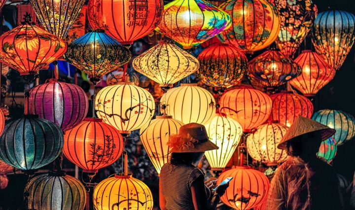 two person standing near assorted color paper lanterns