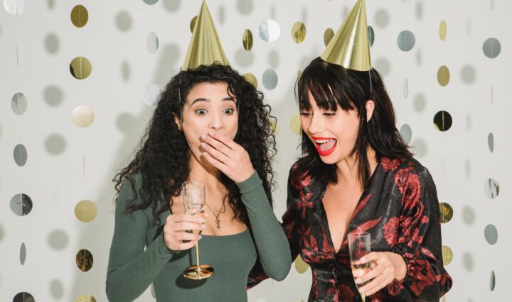 emotional women celebrating holiday with champagne